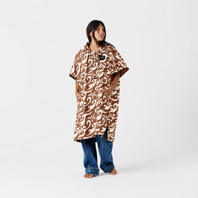 Changing poncho made from recycled materials with brown and white pattern.