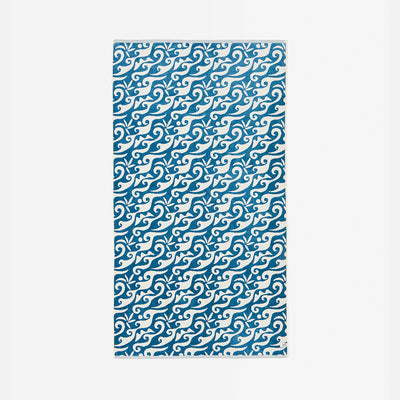 Blue and white rug with swirling wave pattern.