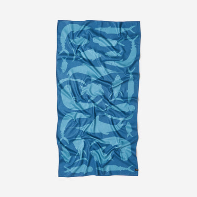Sand-free towel with light blue fish pattern.