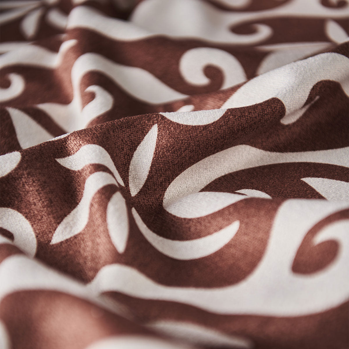 Adventure blanket with brown and white swirling floral pattern fabric.