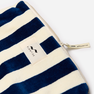 Terry pouch with blue and white stripes, zipper closure.