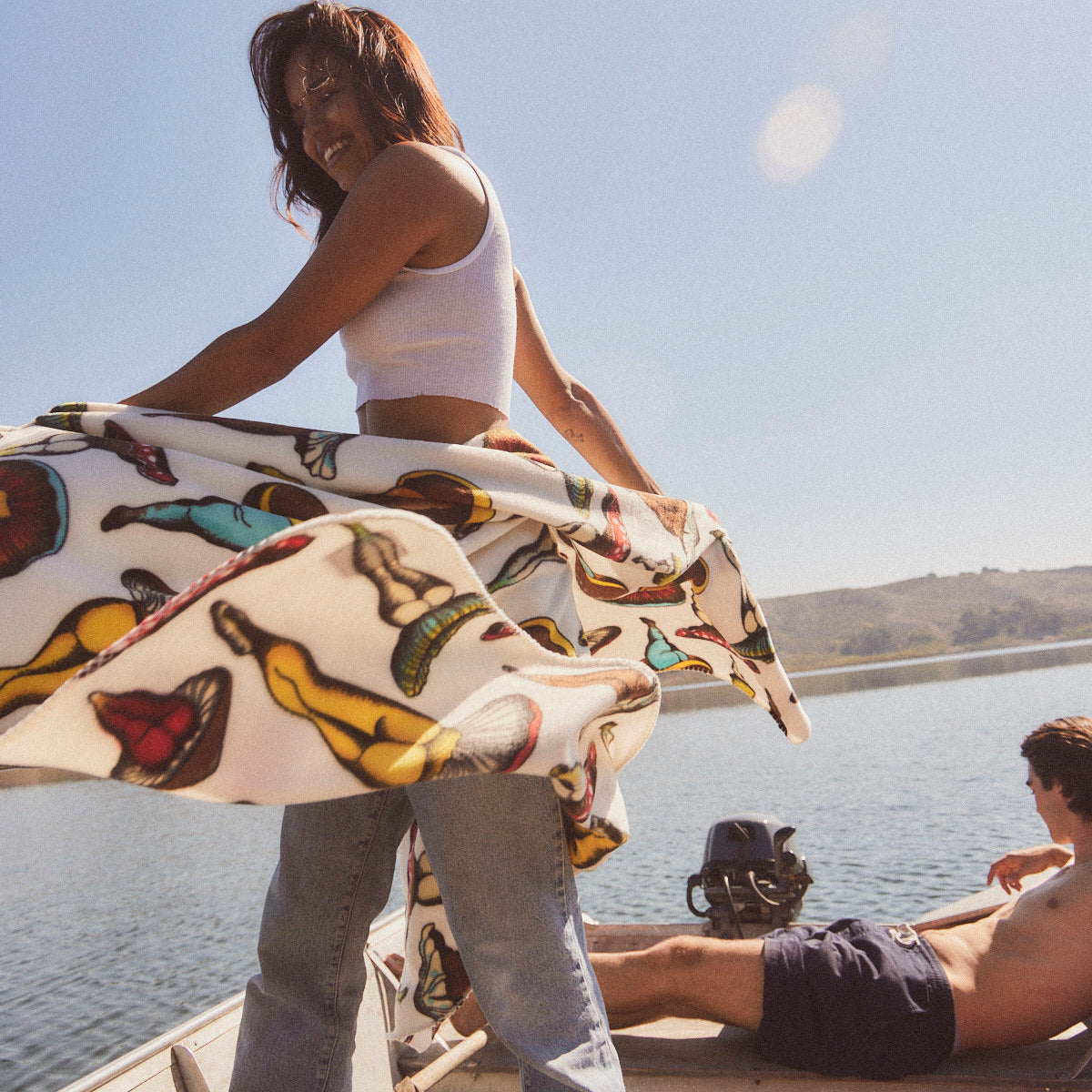 Polar fleece blanket with colorful pattern outdoors on a sunny day.