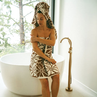Bath towel and hair wrap set in a brown and white floral pattern.