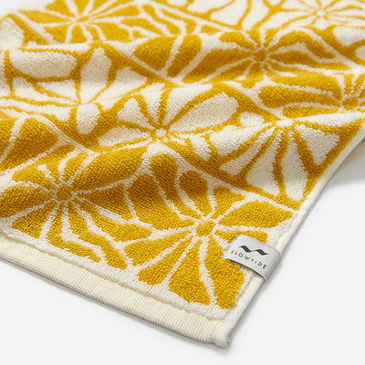 Hand towel, 550 GSM cotton, yellow and white floral pattern.