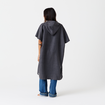 Gray quick-drying changing poncho with jeans, back view.