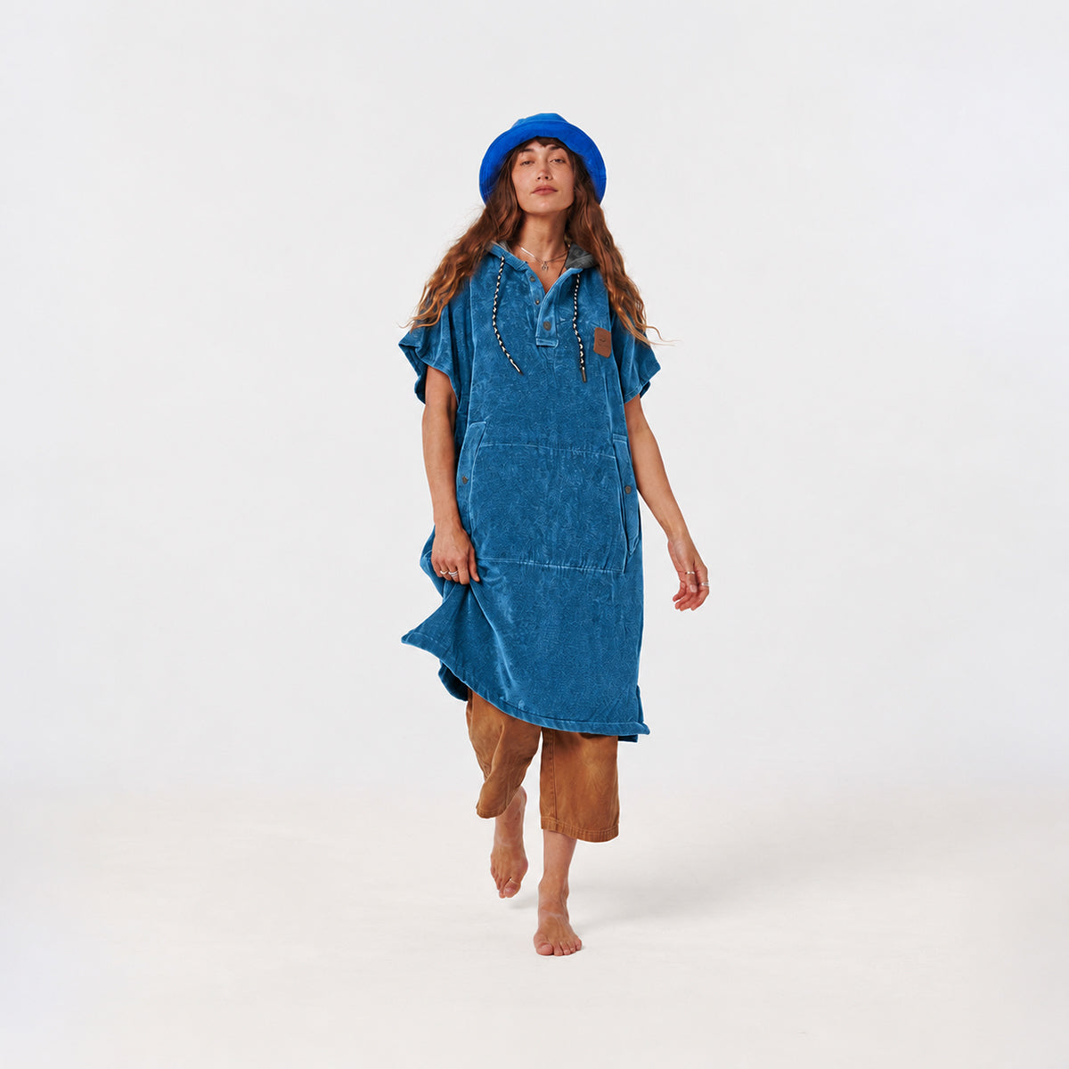 Hooded towel poncho in blue with a front pocket and button placket.