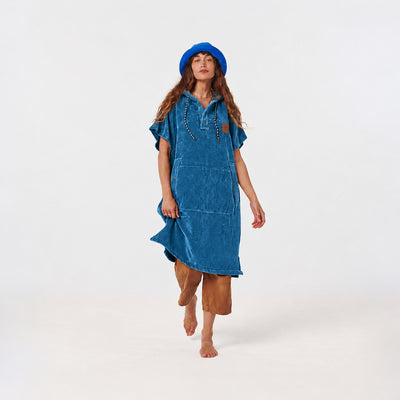 Hooded towel poncho in blue with a front pocket and button placket.