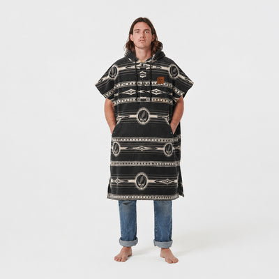 Patterned changing poncho with rolled-up hem, likely cotton or microfiber, studio setting.