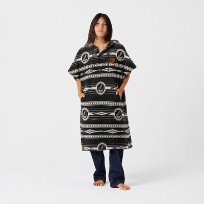 Patterned towel poncho with geometric design.