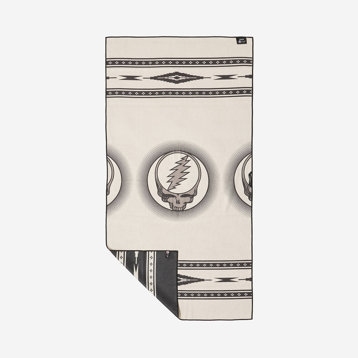 Quick-drying blanket, beige and black with skull, lightning bolt, and geometric patterns.