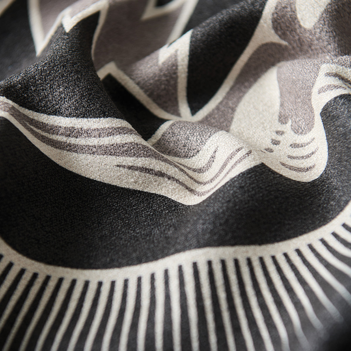 Fabric, quick-drying black material with white and beige abstract curved pattern.