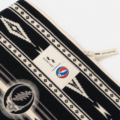 Terry pouch with black and white pattern and skull logo.