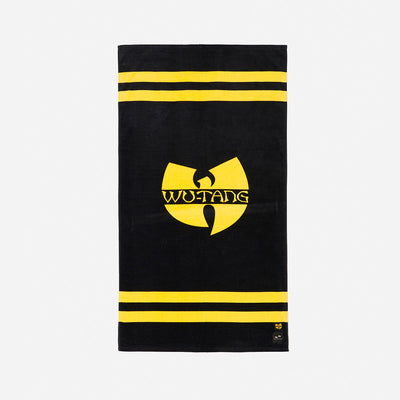 Velour towel with yellow logo and stripes on black.