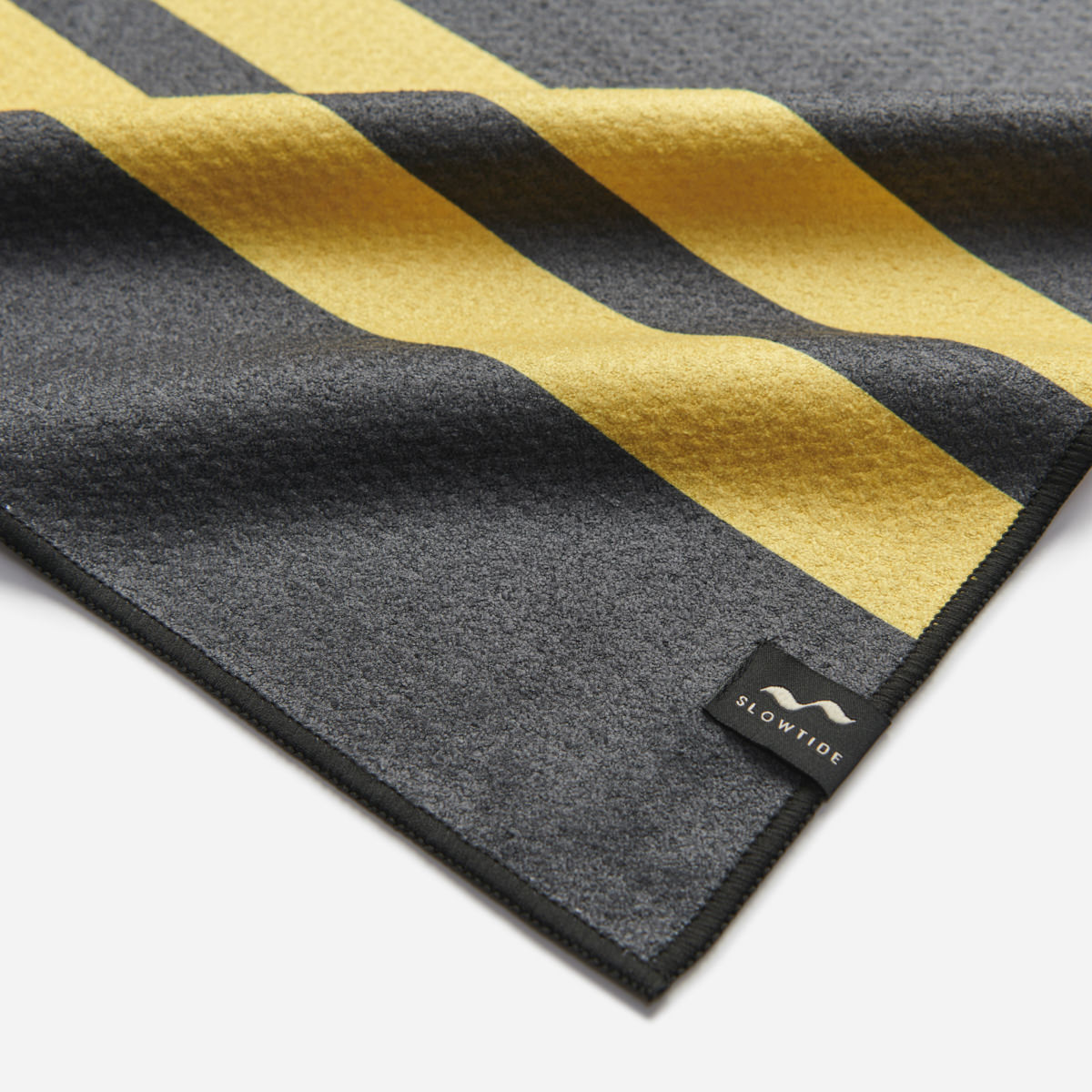 Gray recycled microfiber kitchen towel with yellow stripes, close-up.