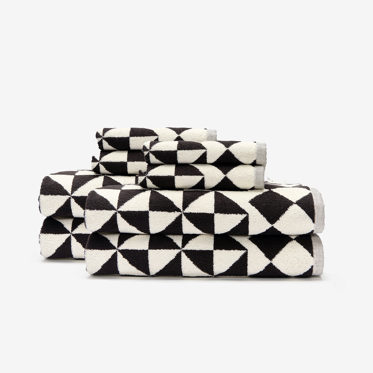 Cotton towels with bold geometric pattern stacked neatly.