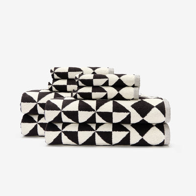 Cotton towels with bold geometric pattern stacked neatly.