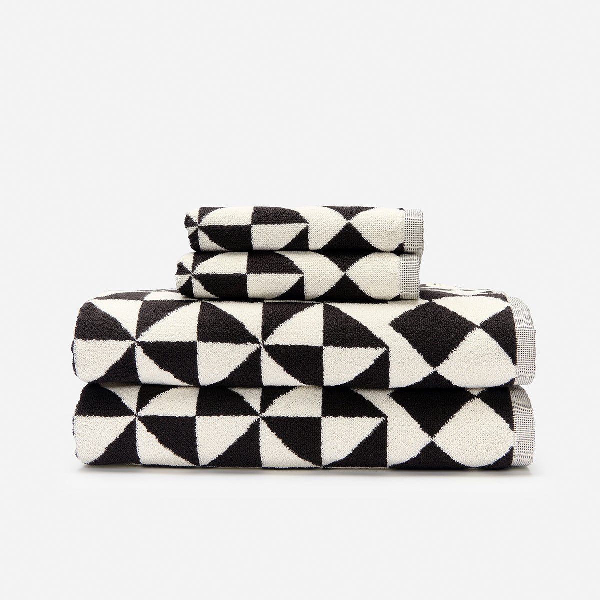 Cotton bath towels with black and white geometric triangle pattern.