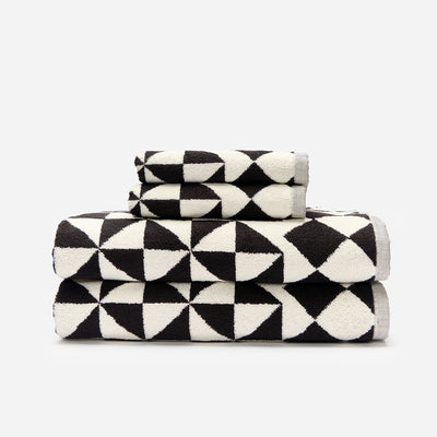 Cotton bath towels with black and white geometric triangle pattern.