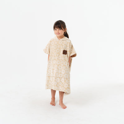 Beige floral cotton terry hooded towel with floral pattern.