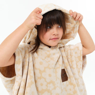 Kids beige floral cotton terry hooded towel poncho with hood up.