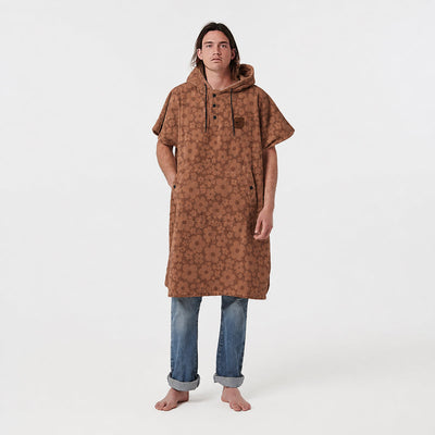 Cotton poncho with brown floral pattern.