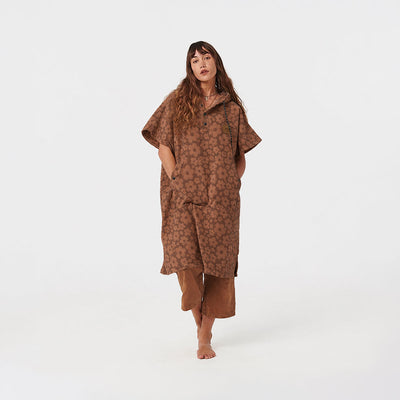 Cotton poncho with brown floral pattern and matching brown pants.