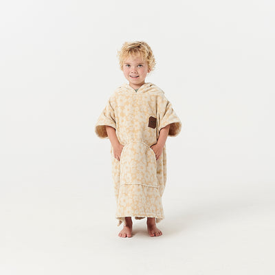Kids poncho, beige with floral pattern.