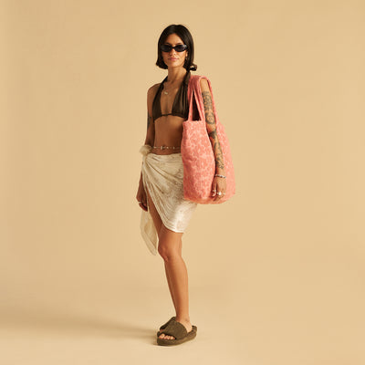 Cotton tote bag, sustainably sourced, paired with wrap skirt and bikini top.