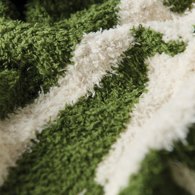 Cotton towel with soft green and white woven pattern, close-up texture view.