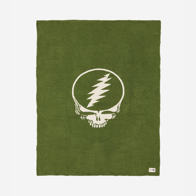 Green rug with white skull and lightning bolt pattern.