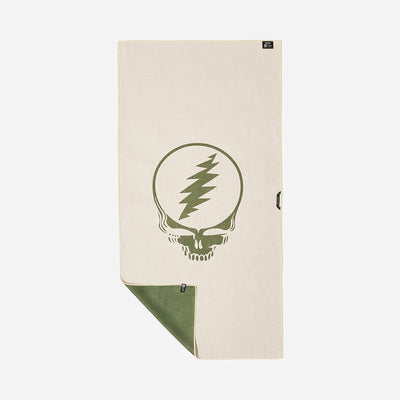 Beige quick-dry towel with green graphic, flipped corner shows green underside.