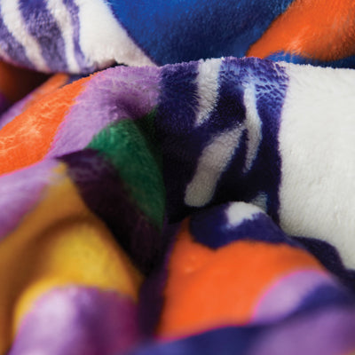 Plush throw blanket with orange, purple, green, and blue pattern.