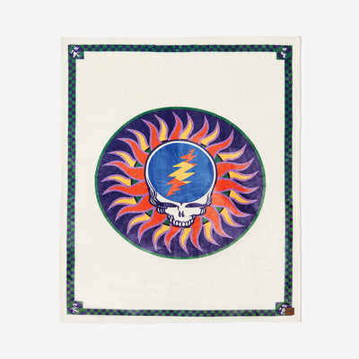 Oversized plush throw blanket with skull and lightning bolt sunburst design.