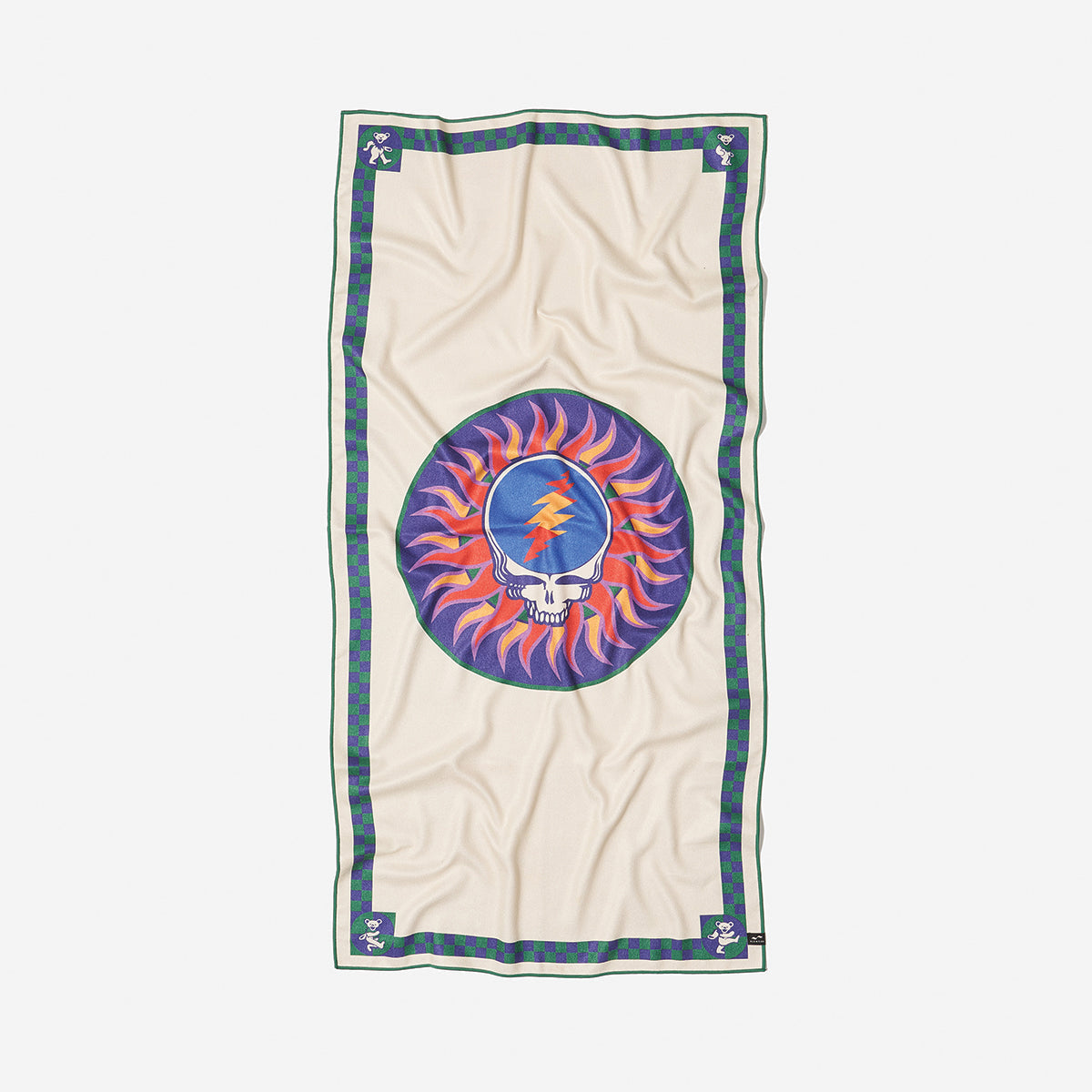 Beige sustainable towel with skull and lightning bolt in a colorful sunburst circle pattern.