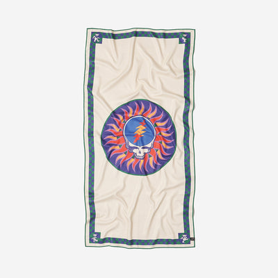 Beige sustainable towel with skull and lightning bolt in a colorful sunburst circle pattern.