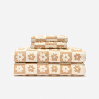 Bath towels, sustainable cotton, beige and white floral checkerboard pattern.