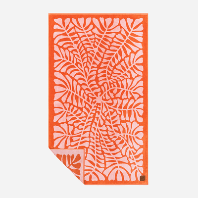 Beach towel, jacquard fabric, orange and pink leaf pattern, solid orange border.