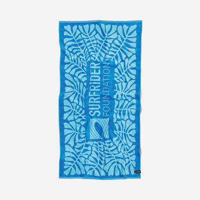 Blue cotton beach towel with leaf pattern and text, made from sustainable materials.