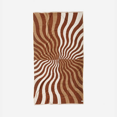 Oversized towel with wavy brown and cream retro stripes.