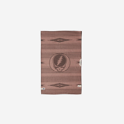 Brown towel, absorbent material with skull logo and geometric pattern, for bathroom or beach use.