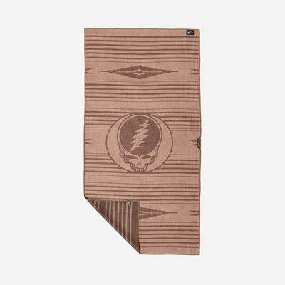 Quick-dry brown towel with geometric pattern and lightning skull logo on plain background.