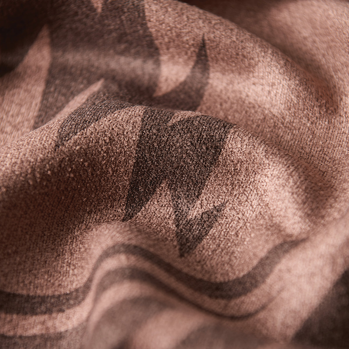 Textured brown fabric, recycled material, black zigzag and stripe pattern for upholstery or crafts.