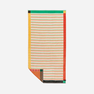 Cotton beach towel with multicolored stripes and solid borders.