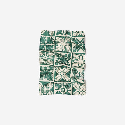 Microfiber kitchen towel with green and white floral leaf grid pattern.