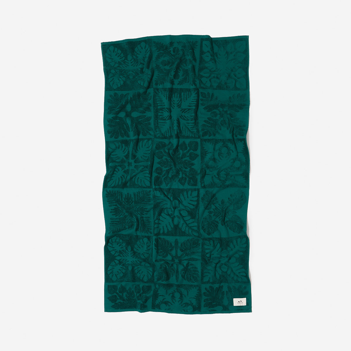 Cotton towel, green, sustainable, with textured leaf pattern, flat on white background.