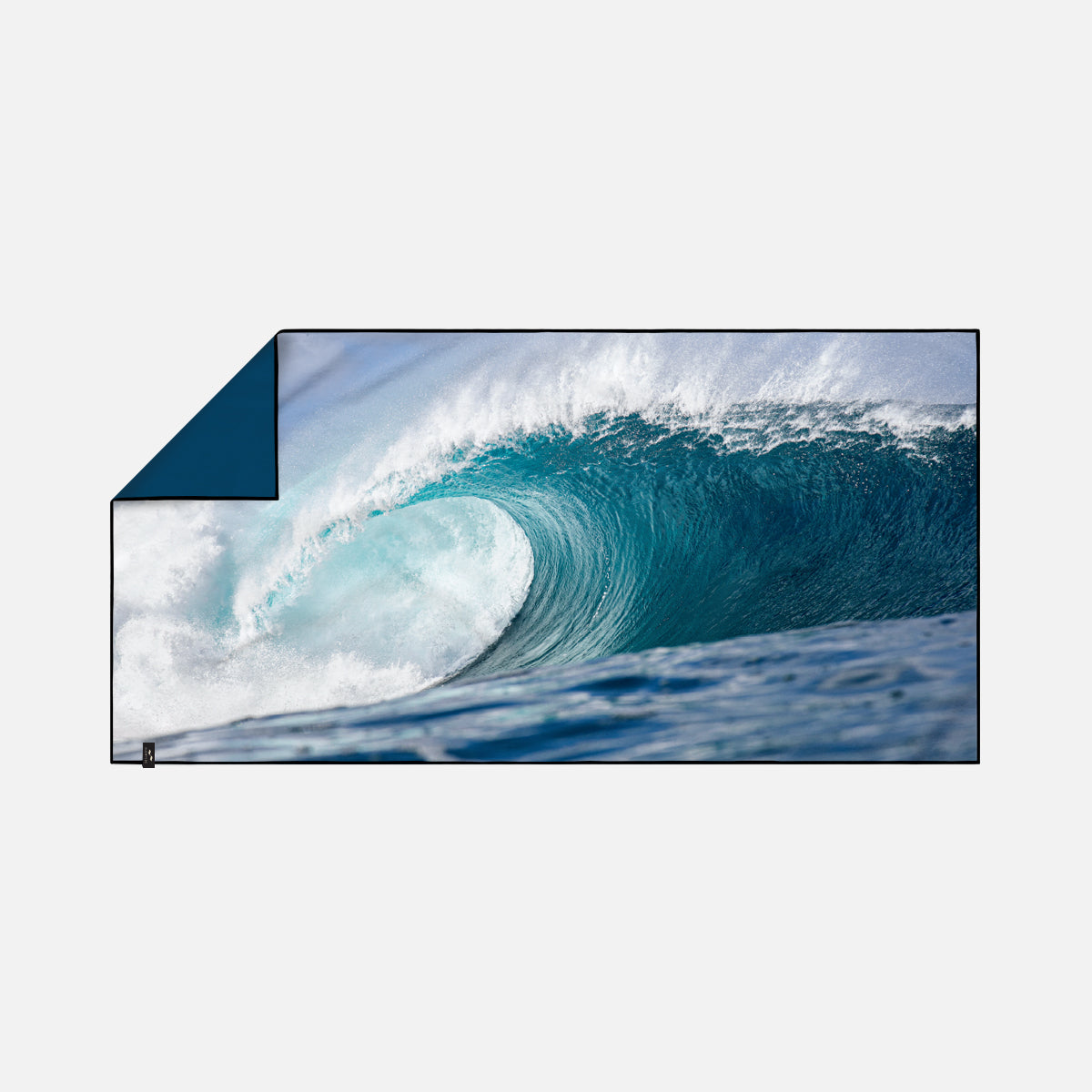 Sand resistant towel with large ocean wave design on white background.
