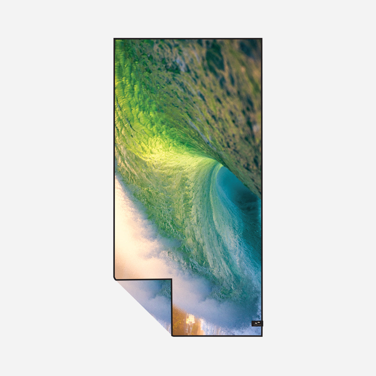 Sand-resistant towel with green ocean wave pattern, shown in natural sunlight.