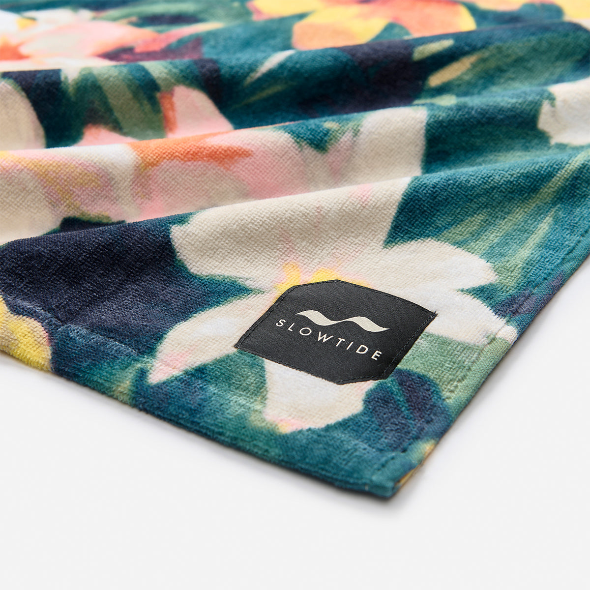 Beach towel in colorful floral pattern, sustainably sourced cotton.