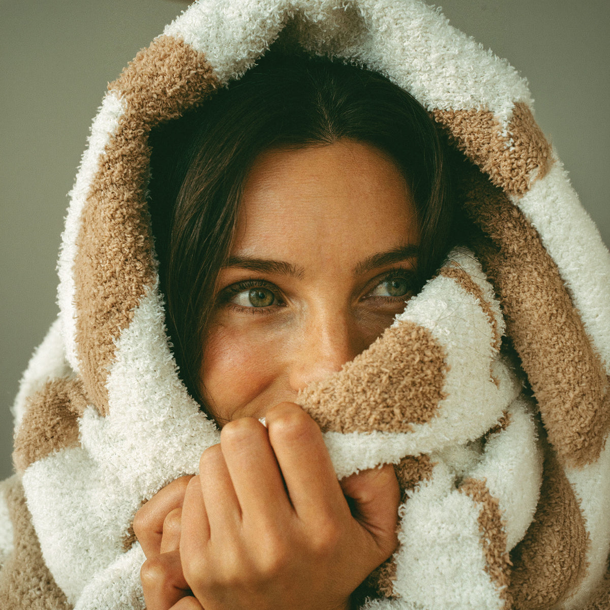 Plush hooded robe in a tan and white speckled knit pattern.