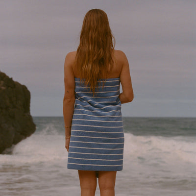 Striped changing poncho with hood, terry fabric, beach setting.